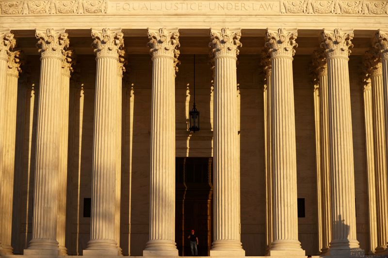 © Reuters. FILE PHOTO: A man walks at the U.S. Supreme Court building in Washington