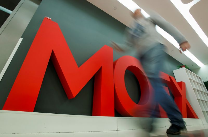 &copy; Reuters. A man walks past a logo of the Moscow Exchange inside its office in Moscow