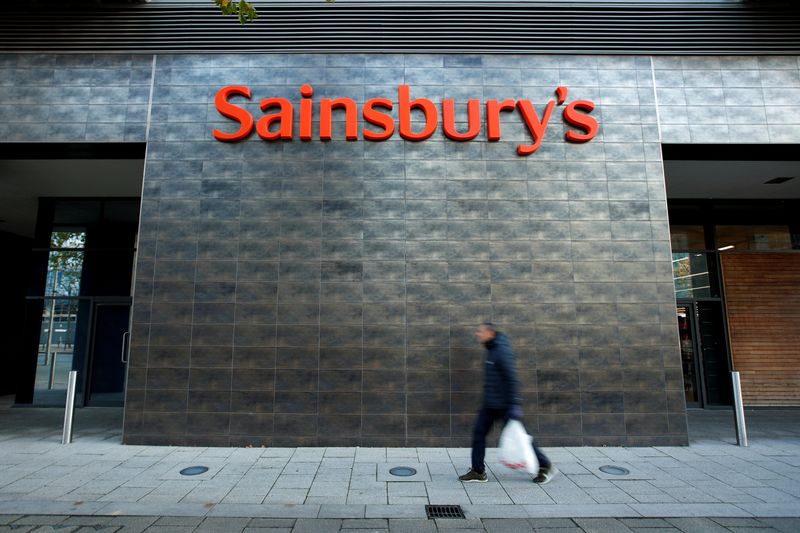 &copy; Reuters. FILE PHOTO: A person walks past a Sainsbury&apos;s store in Milton Keynes