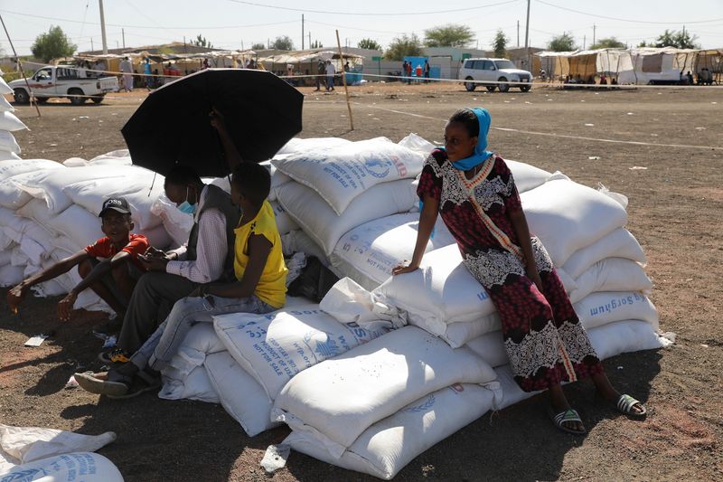 &copy; Reuters. FILE PHOTO:  Ethiopian refugees sit on bags of food aid at the Village 8 refugees transit camp, which houses Ethiopian refugees fleeing the fighting in the Tigray region, near the Sudan-Ethiopia border