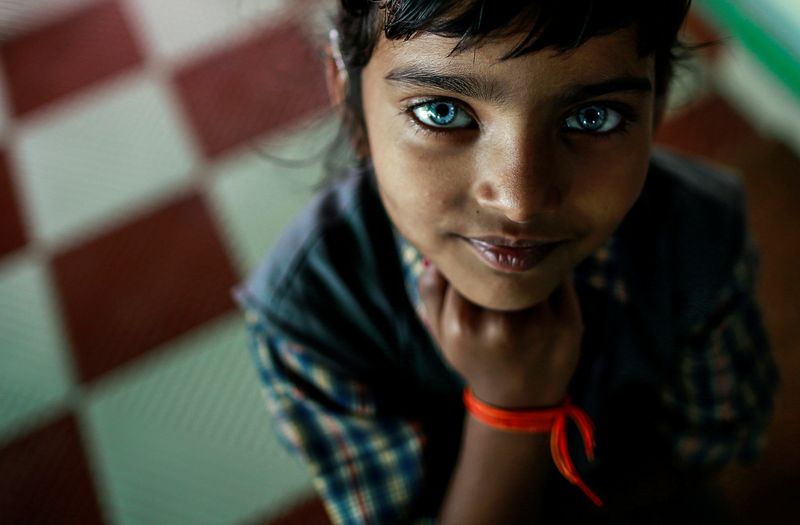 © Reuters. FILE PHOTO: File photo of a girl who suffers from hearing and speech disorders reacting to the camera at a rehabilitation centre for children who were born with mental and physical disabilities in Bhopal
