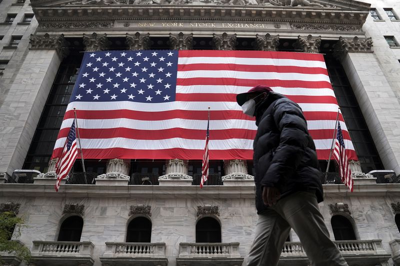 &copy; Reuters. FILE PHOTO: A man walks past the New York Stock Exchange in the Manhattan borough of New York City