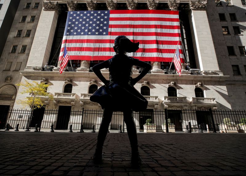 &copy; Reuters. FILE PHOTO: The Fearless Girl statue is seen as the  U.S. flag covers the front facade of the NYSE in New York