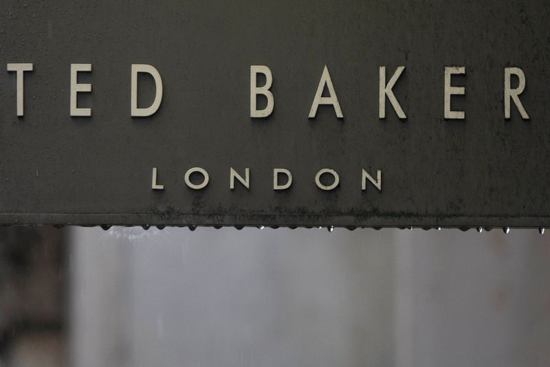 &copy; Reuters. Rain drips off a sign on a Ted Baker sign on a store in London, Britain