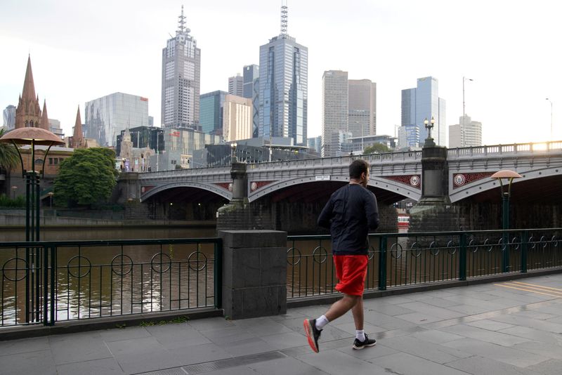&copy; Reuters. A solitary man runs along a waterway under COVID-19 lockdown restrictions in Melbourne