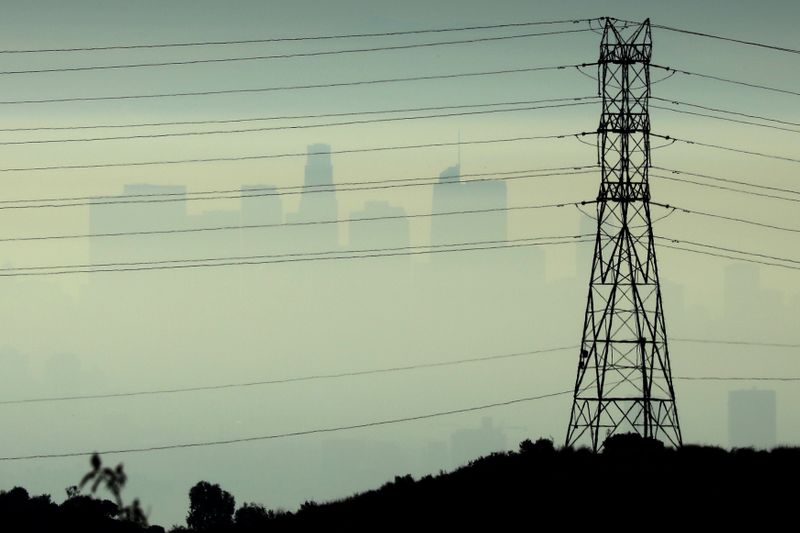 &copy; Reuters. FILE PHOTO: Downtown Los Angeles is seen behind an electricity pylon through the morning marine layer in Los Angeles