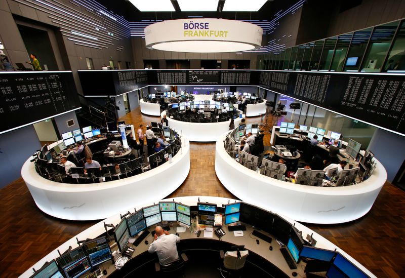 &copy; Reuters. FILE PHOTO: Traders work at their screens in front of the German share price index DAX board at the stock exchange in Frankfurt