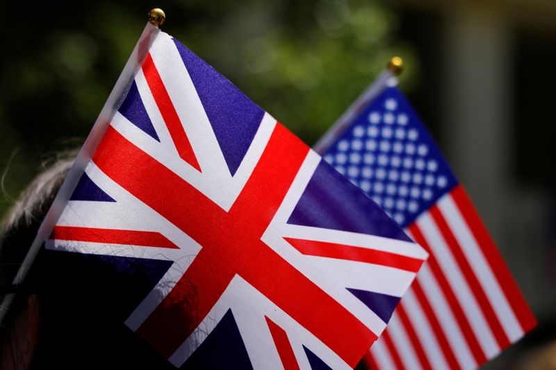 © Reuters. FILE PHOTO: A student at Meghan Markle's former Los Angeles high school wears British and American flags she takes part in a 'Here's to Meghan!' celebration ahead of her marriage to Prince Harry, as they celebrate at Immaculate Heart High School in Los Ang