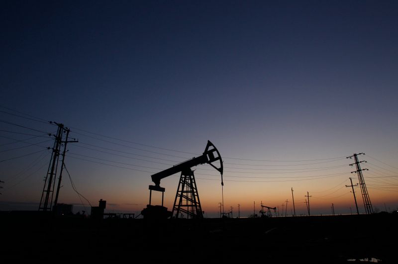 &copy; Reuters. Pump jacks are silhouetted against the rising sun at an oilfield in Baku