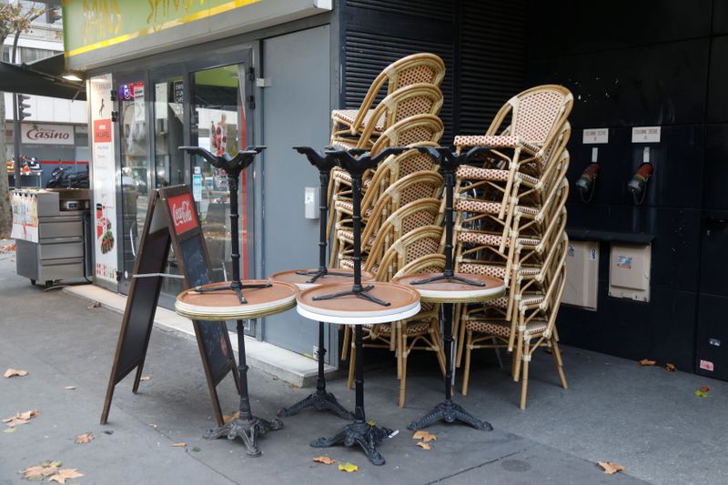 &copy; Reuters. Chairs are stacked outside a closed restaurant in Paris