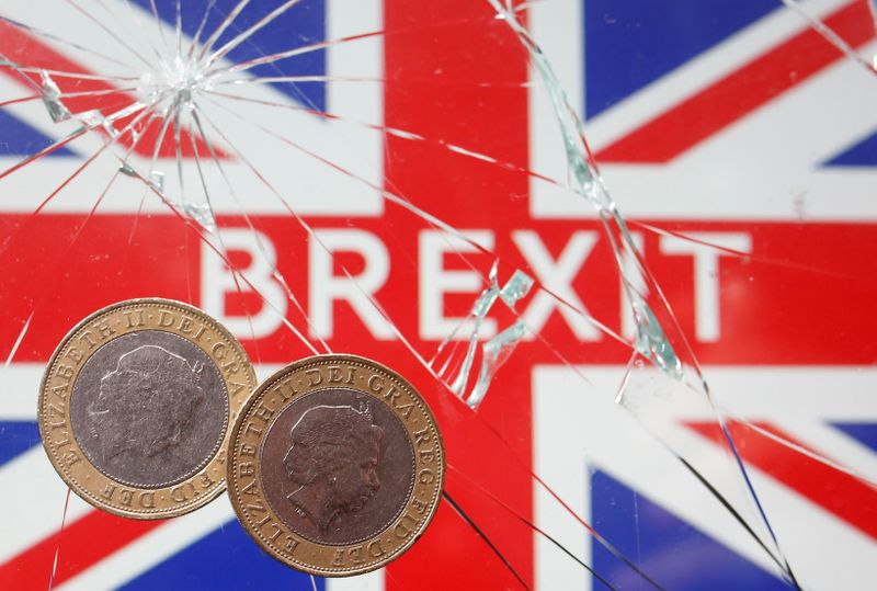 &copy; Reuters. A pound coins are placed on broken glass and British flag in this illustration picture taken