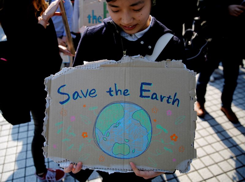 &copy; Reuters. FILE PHOTO: A school student holds a sign as she takes part in the global students strike for action on climate change in Tokyo