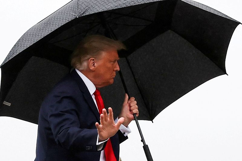&copy; Reuters. FILE PHOTO: U.S. President Donald Trump carries an umbrella while boarding Air Force One at Joint Base Andrews, Maryland