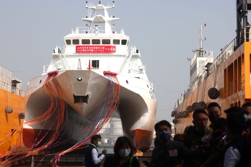 &copy; Reuters. Reporters conduct an interview in front of the Cheng Kung ship at the launch of the first of a new generation of coast guard patrol ships in Kaohsiung