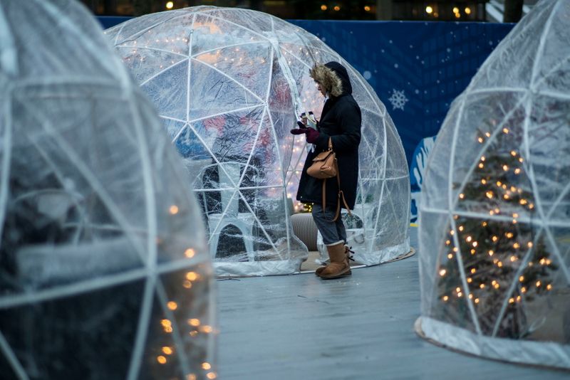 &copy; Reuters. A woman waits to go inside of an igloo with Christmas decorations as the global outbreak of the coronavirus disease (COVID-19) continues, in New York