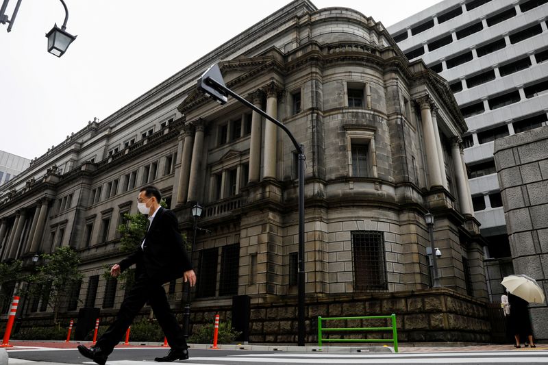 &copy; Reuters. FILE PHOTO: A man wearing a protective mask walks past the headquarters of Bank of Japan amid the coronavirus disease (COVID-19) outbreak in Tokyo