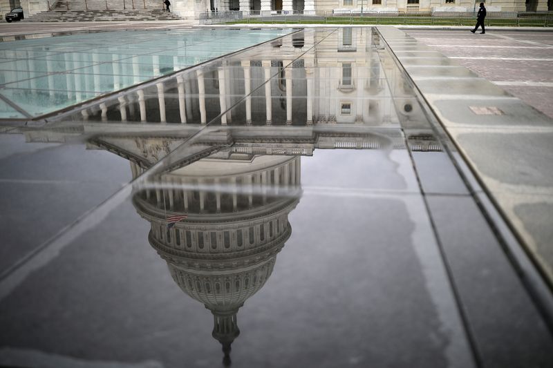 &copy; Reuters. The U.S. Capitol Building is reflected on a marble seating area following a rainstorm at the East Front on Capitol Hill in Washington