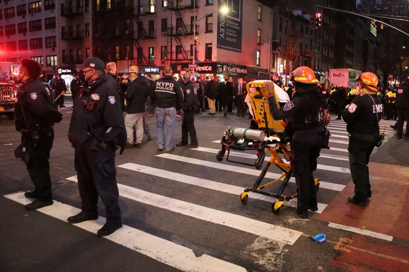 © Reuters. Police and EMS stand in the street at the location of a vehicle that struck multiple pedestrians on Third Avenue