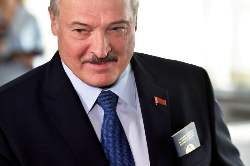 &copy; Reuters. FILE PHOTO: Belarusian President Alexander Lukashenko visits a polling station during the presidential election in Minsk