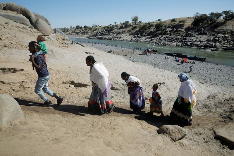 © Reuters. FILE PHOTO: Ethiopians who have just crossed a river from Ethiopia to Sudan to flee from Tigray region