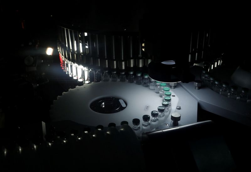 © Reuters. Vials of AstraZeneca's COVISHIELD, coronavirus disease (COVID-19) vaccine are seen inside a visual inspection machine inside a lab at the Serum Institute of India, Pune