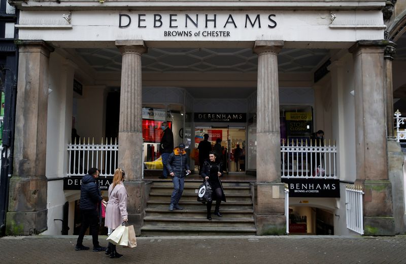 © Reuters. Shoppers walk out of a Debenhams store in Chester, Britain