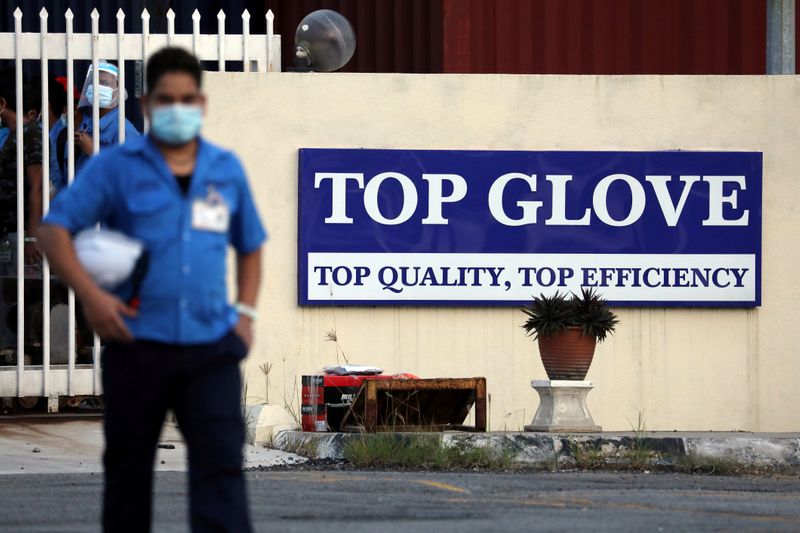 &copy; Reuters. A worker leaves a Top Glove factory after his shift in Klang