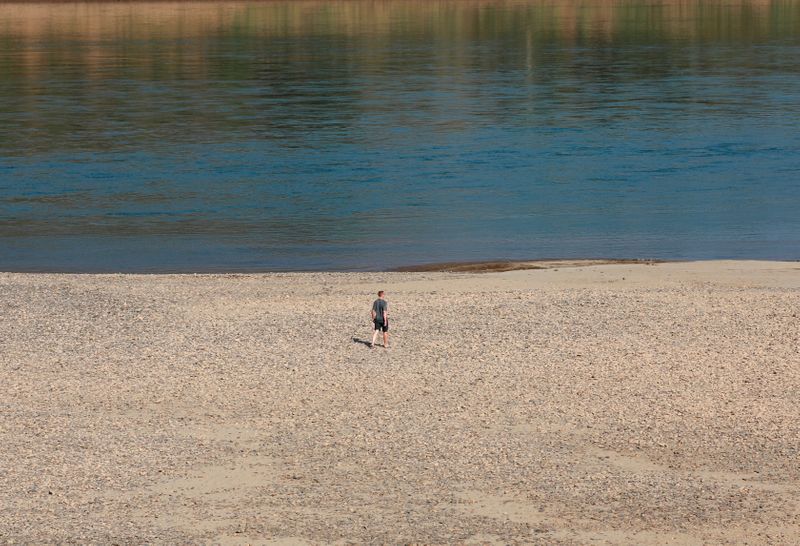 &copy; Reuters. FILE PHOTO: Tourist walks on the Mekong river bank outside Loei