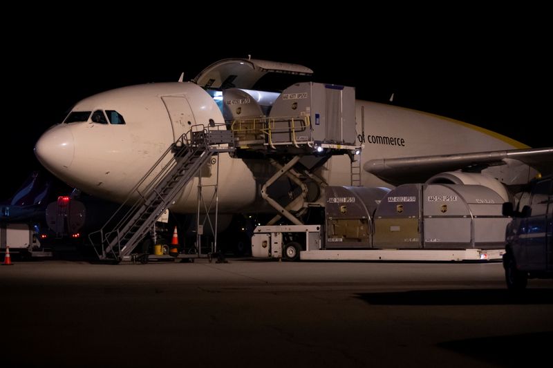 © Reuters. Canada's first batch of Pfizer/BioNTEch COVID-19 vaccines are unloaded from a UPS cargo plane at Montreal-Mirabel International Airport