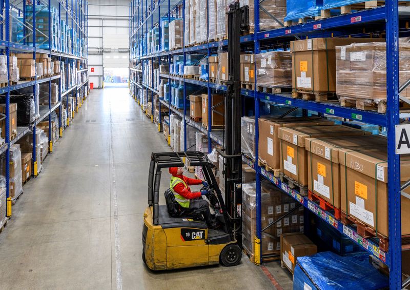 © Reuters. FILE PHOTO: Worker operates a forklift at Europa Worldwide Group's warehouse in Dartford, Britain in this undated handout obtained by Reuters November 28, 2020.