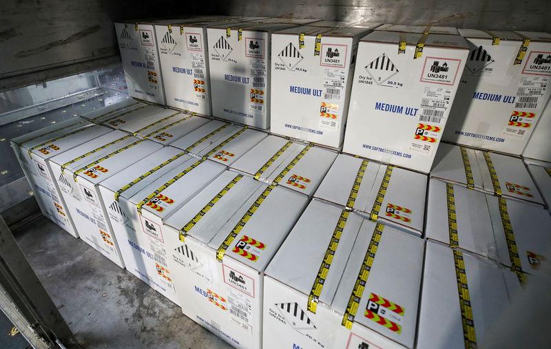 &copy; Reuters. Boxes containing Pfizer&apos;s COVID-19 vaccine are unloaded from air shipping containers at UPS Worldport, in Louisville, Kentucky