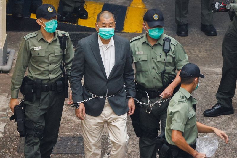 &copy; Reuters. Media mogul Jimmy Lai Chee-ying, founder of Apple Daily, walks to a prison van to head to court, after being charged under the national security law, in Hong Kong