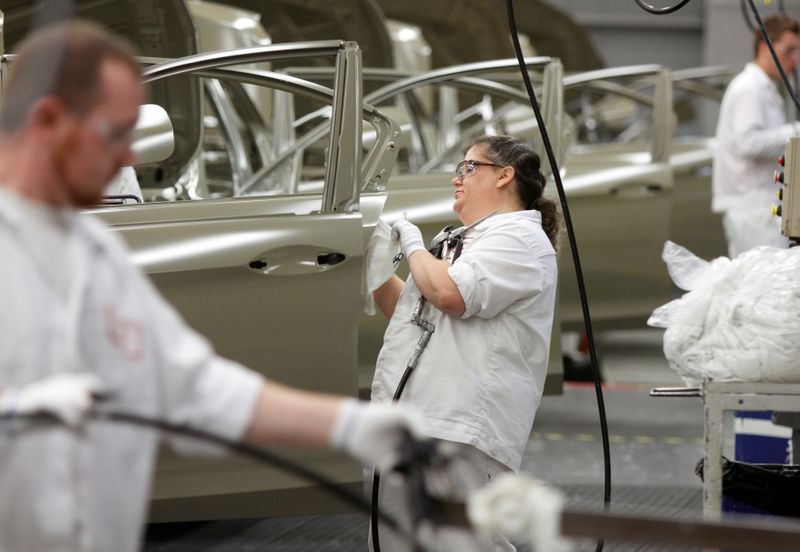 &copy; Reuters. An employee works on the sealer line in the paint department during a tour of an automobile plant in Marysville