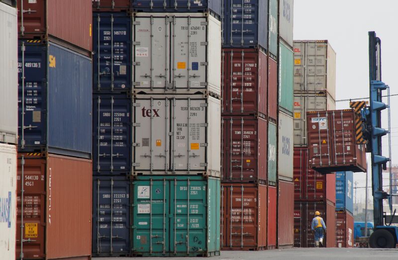 &copy; Reuters. A laborer works in a container area at a port in Tokyo