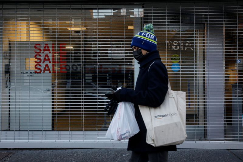 &copy; Reuters. A shopper passes by a retail store that was recently closed in Brooklyn, New York