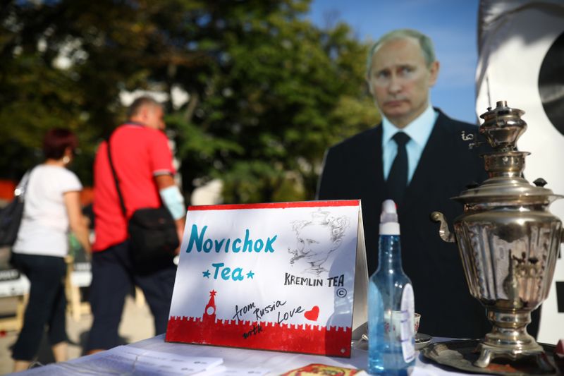 &copy; Reuters. People pass a mock offer of &quot;Novichok Tea&quot; outside the Russian embassy in Berlin