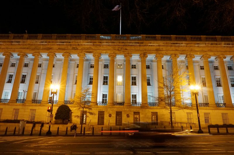 © Reuters. FILE PHOTO:  A vehicle drives past the U.S. Treasury Department in Washington