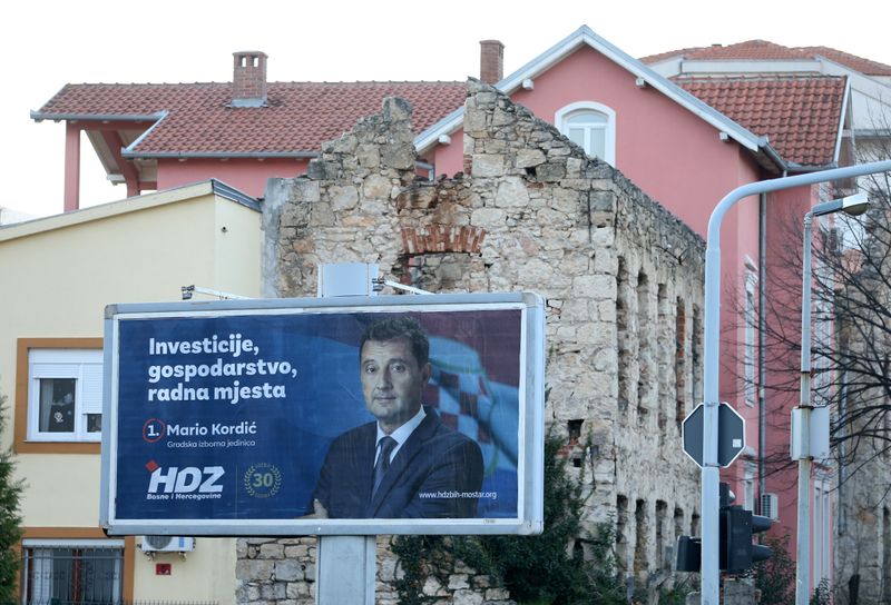 &copy; Reuters. An election sign is seen in front of a house that was destroyed during the 1992-1995 war, in Mostar