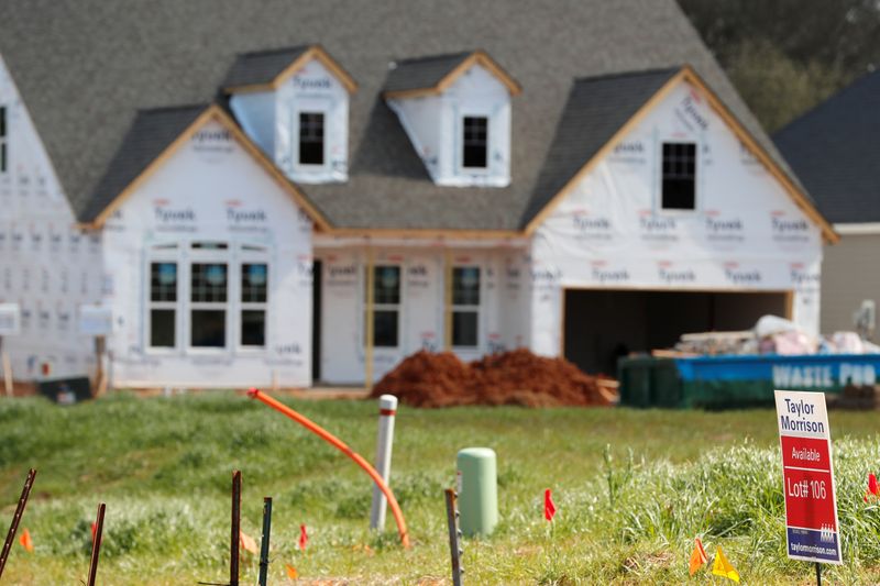 &copy; Reuters. A home under construction stands behind a real estate sign in a new development in York County, South Carolina