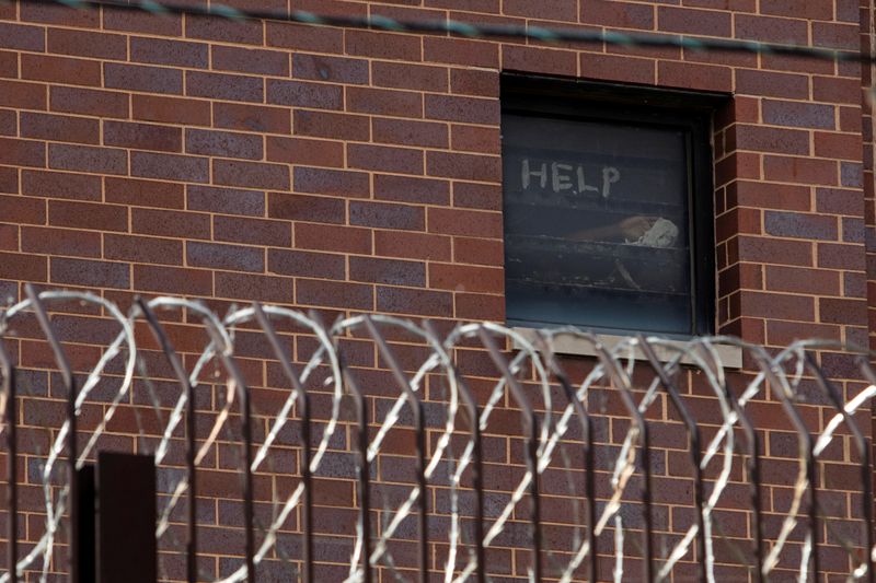 &copy; Reuters. Signs made by prisoners pleading for help are seen in a window of Cook County Jail in Chicago