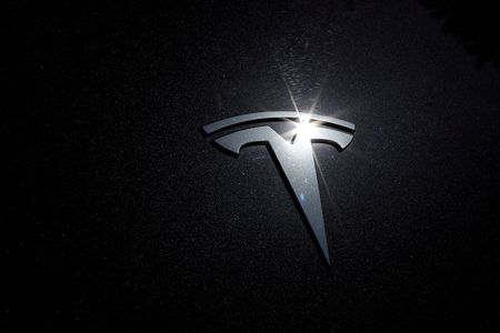 Tesla shares rise in busy trade ahead of S&P 500 debut By Reuters