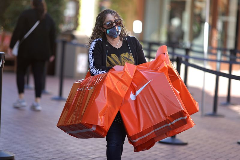 &copy; Reuters. FILE PHOTO: A woman carries Nike shopping bags at the Citadel Outlet mall, as the global outbreak of the coronavirus disease (COVID-19) continues, in Commerce