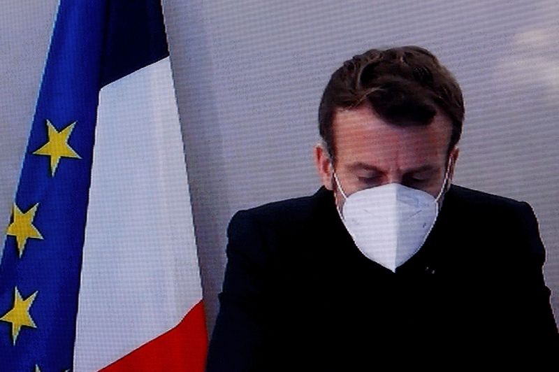 &copy; Reuters. French President Macron, tested positive for coronavirus, is seen on TV screen