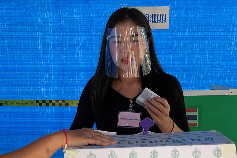 &copy; Reuters. A woman wearing a face shield votes in the provincial election in Nonthaburi, Thailand