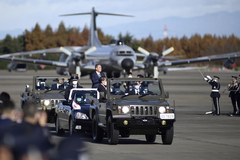 &copy; Reuters. FILE PHOTO: Japanese Prime Minister Yoshihide Suga reviews Japan&apos;s Air Self-Defense Force