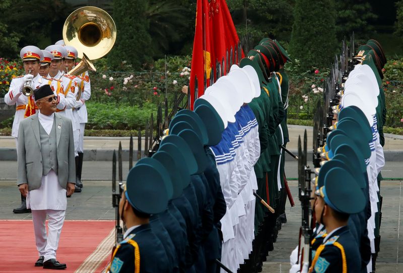 &copy; Reuters. Nepal&apos;s PM K. P. Oli reviews the guard of honour during a welcoming ceremony at the Presidential Palace in Hanoi