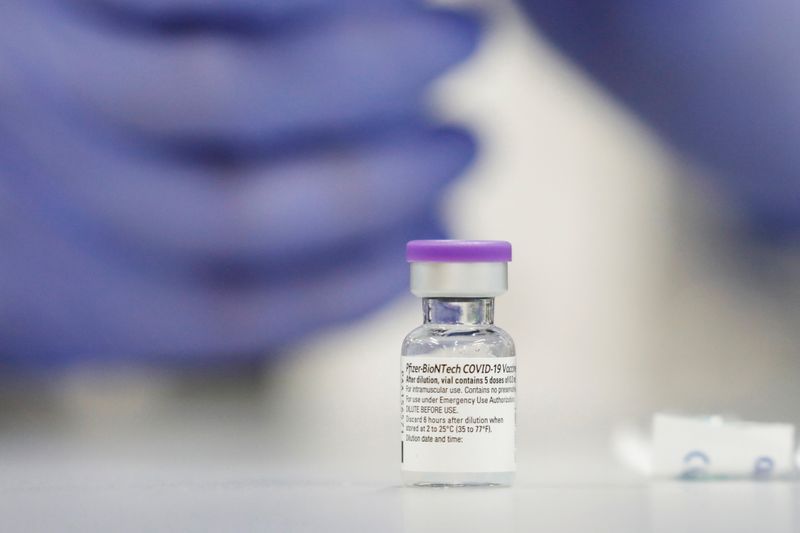 &copy; Reuters. A vial of the Pfizer vaccine against the coronavirus disease (COVID-19) is seen as medical staff are vaccinated at Sheba Medical Center in Ramat Gan, Israel