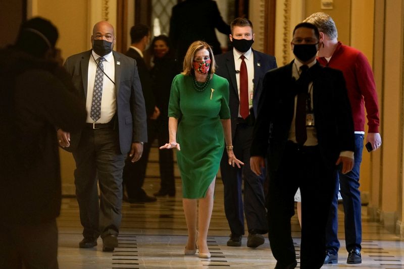 © Reuters. Speaker of the House Nancy Pelosi (D-CA) walks back to her office after opening the House floor following an agreement of a coronavirus disease (COVID-19) aid package, in Washington