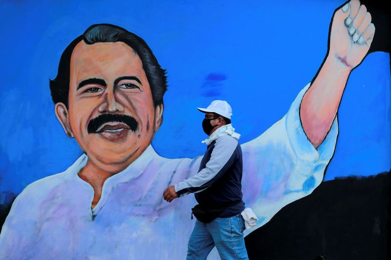 &copy; Reuters. FILE PHOTO: A man walks by a mural depicting Nicaraguan President Daniel Ortega, in Managua