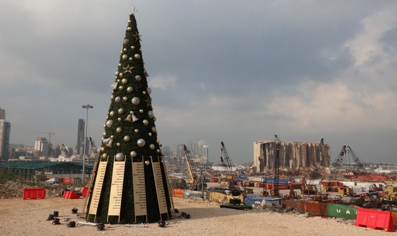 © Reuters. A Christmas tree with names of those who died during Beirut port explosion, is seen near the damaged grain silo, in Beirut